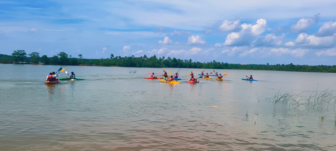 Group of friends on a fun backwater boating adventure in Kurumandal
